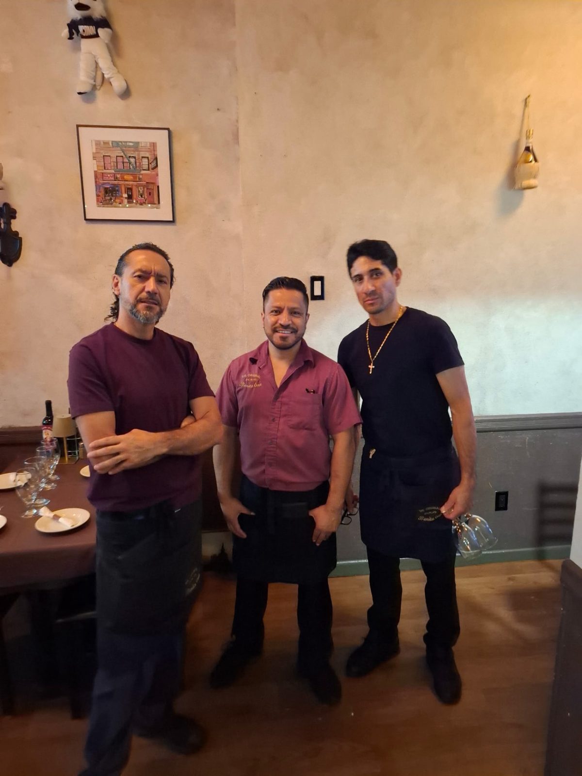 Three people smiling together inside Benito One