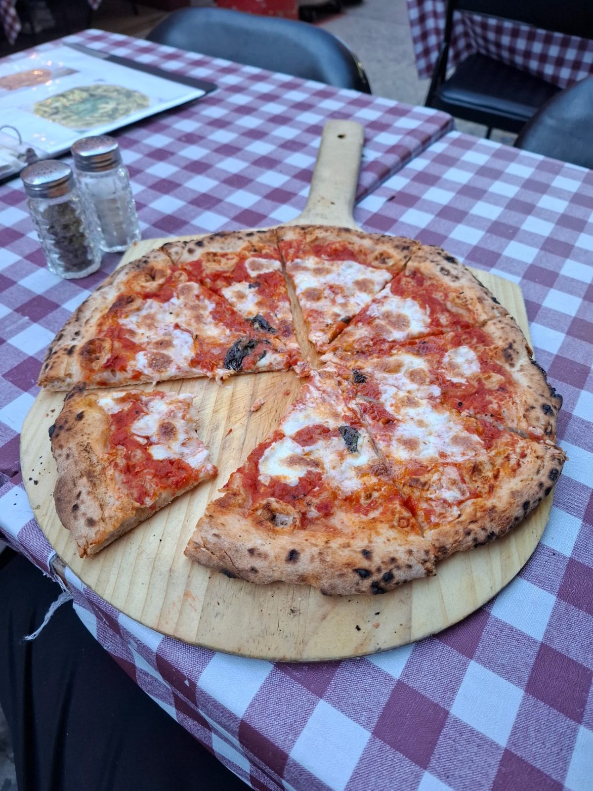 A pizza served on a wooden board